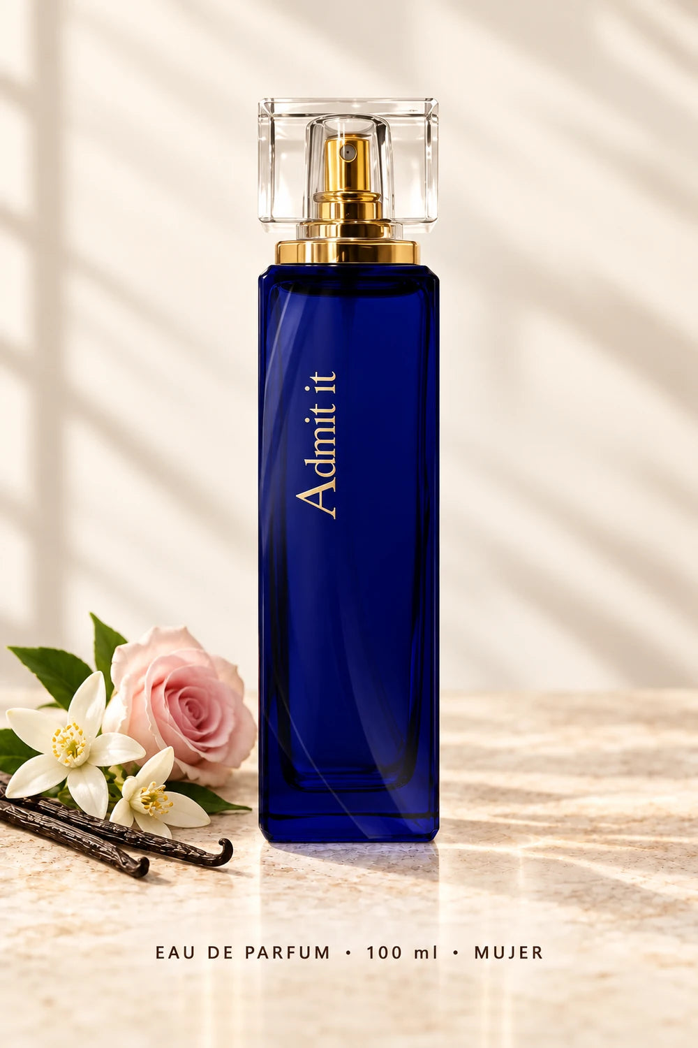 Admit It Eau de Parfum de 100 ml para mujer, frasco azul sobre fondo claro con flores y vainilla.